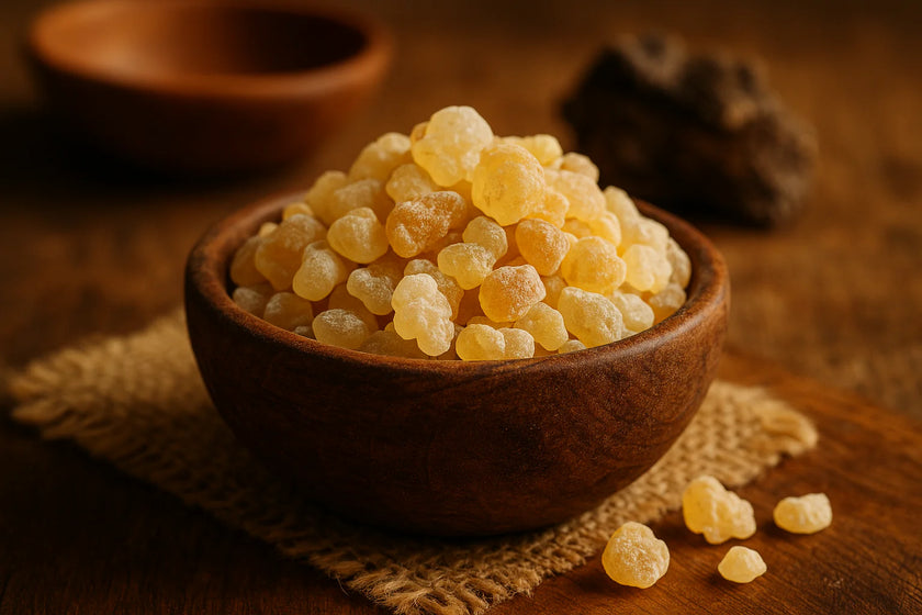 Golden frankincense resin granules in a rustic wooden bowl on a textured cloth, representing a traditional, high-purity ingredient used in natural aromatherapy and therapeutic soy candles.