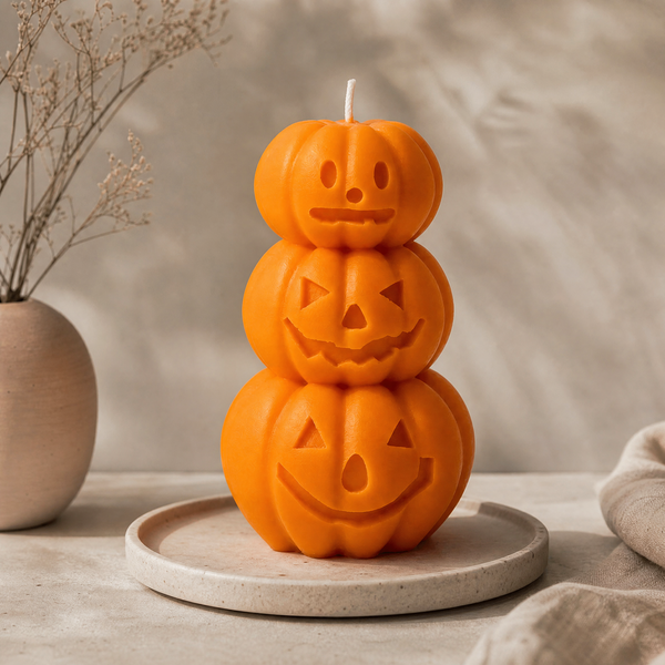 Handmade Halloween pumpkin candle with three stacked jack o lanterns