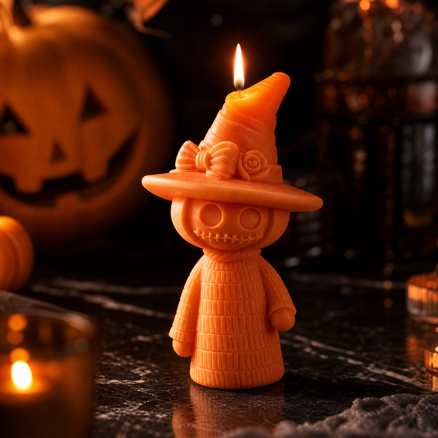 Handmade scarecrow candle with witch hat and bow detail