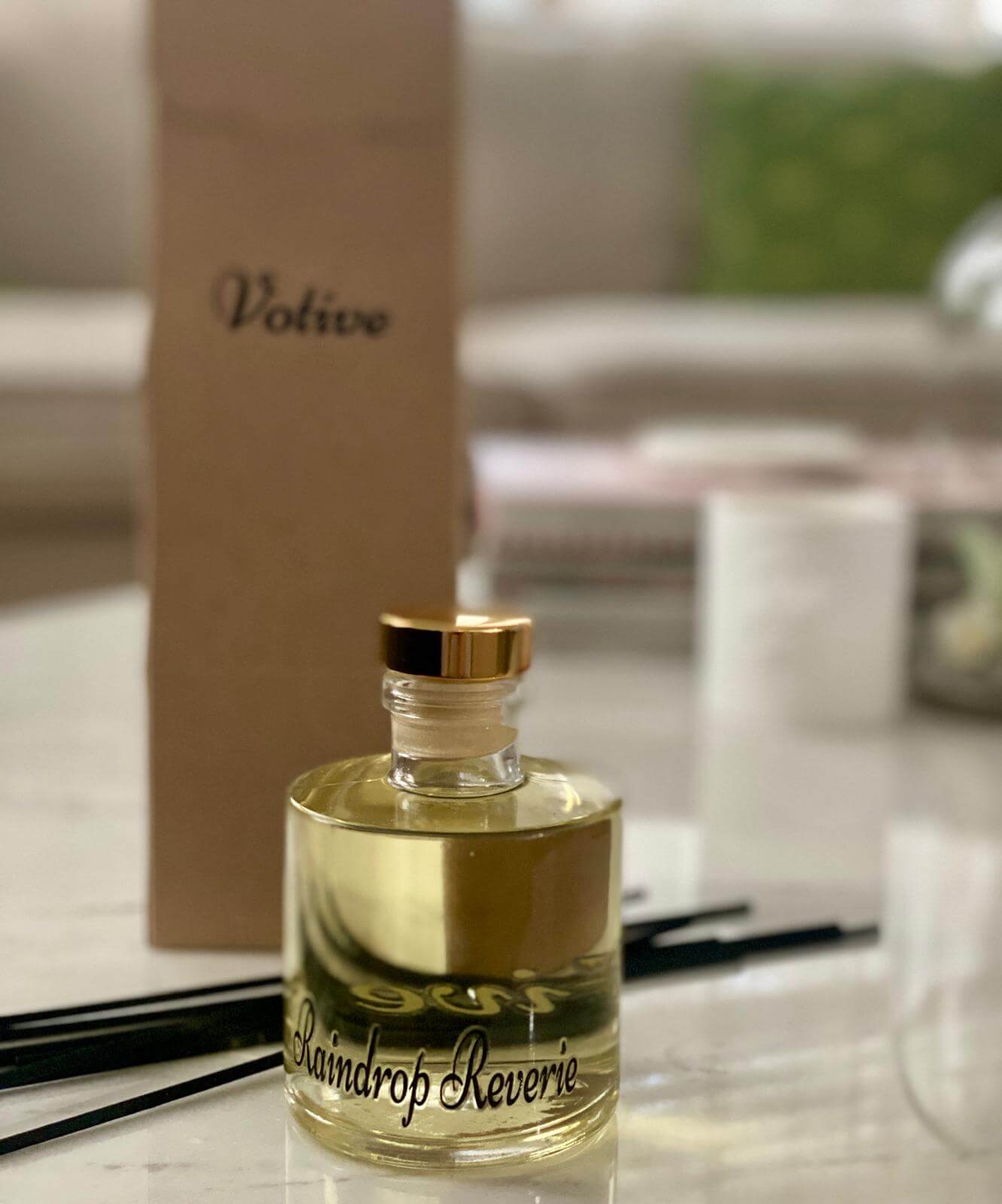 VOTIVE Raindrop Reverie reed diffuser with green botanical background and eco-friendly packaging
