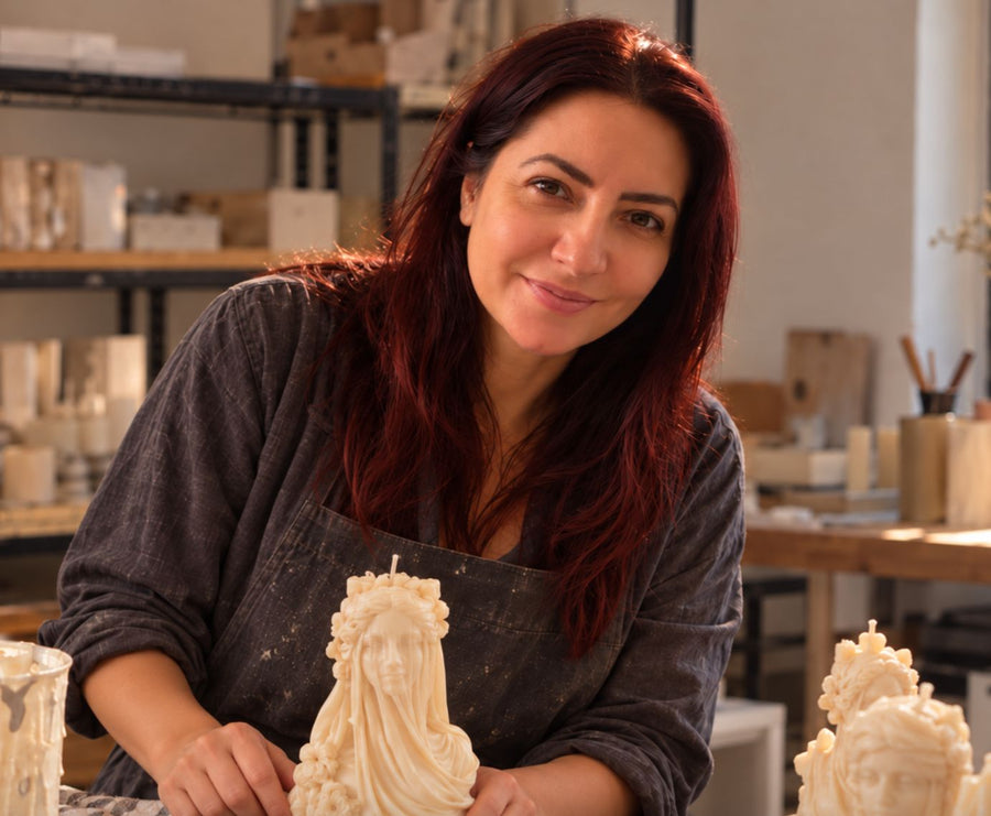 Dana Stance, founder of Votive Candle Co., in the studio with hand-poured sculptural soy wax Veiled Lady candles