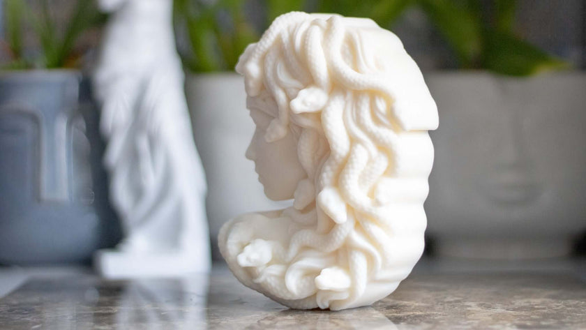 Luxury sculptural candle shaped like Medusa, made from eco-friendly soy wax and infused with a refined fragrance.