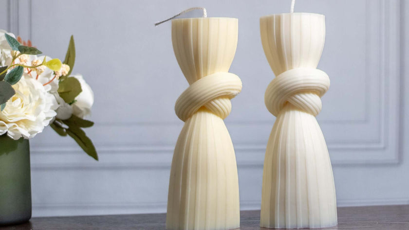 Minimalist knot pillar candle in soft pastel tones, perfect as a statement piece for elegant home decor.