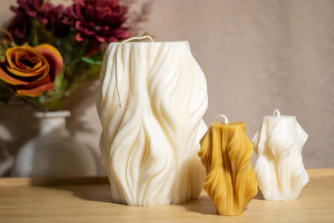 Handcrafted wavy-shaped decorative candle, made from natural soy wax with an elegant flowing design.