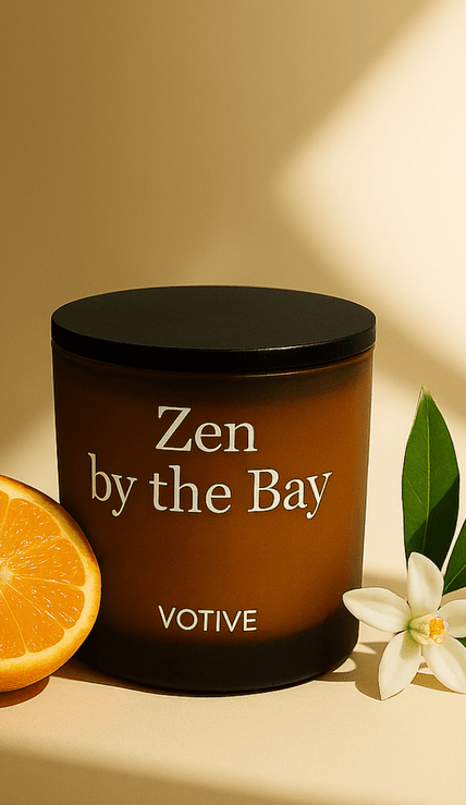 Zen by the Bay scented soy candle with packaging from Votive’s Coastal Wellness Collection on natural stone display