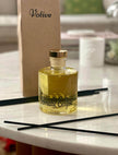 Aromatic Eclipse reed diffuser with white flowers and candles for a relaxing spa atmosphere

