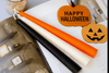 Autumn orange taper candles for seasonal table settings.