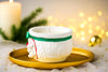 Decorative candle shaped like a lion on a gold plate with a blurred festive background