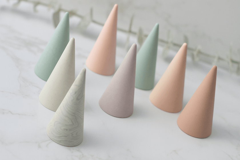 Set of pastel-colored ceramic cones on a light surface