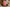 Pink floral-patterned candle on a gold plate with a blurred background