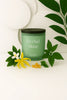 Eco-friendly Herbal Muse candle with soft floral arrangement, perfect for sustainable home styling.