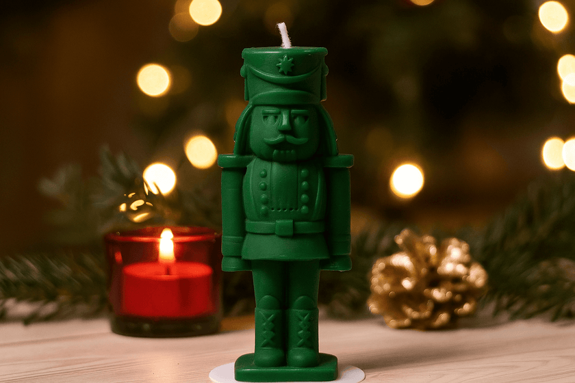 Green nutcracker candle with a blurred festive background
