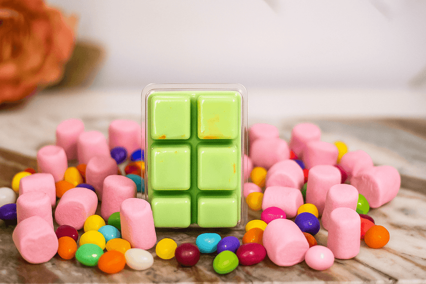 Green soy wax melts in candy-inspired photo setup, non-GMO wax, safe fragrance, hand-poured for sweet and playful home scenting.