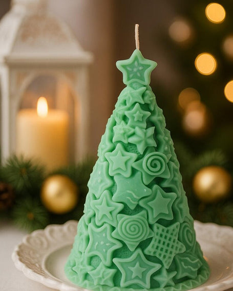 Green Christmas tree-shaped candle on a white plate with festive background