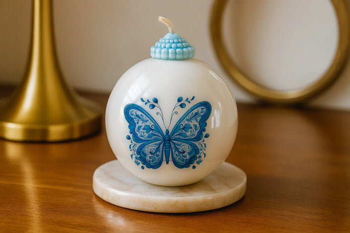 Hand-poured soy wax sculptural candle with vintage ornament shape and blue decorative detailing.
