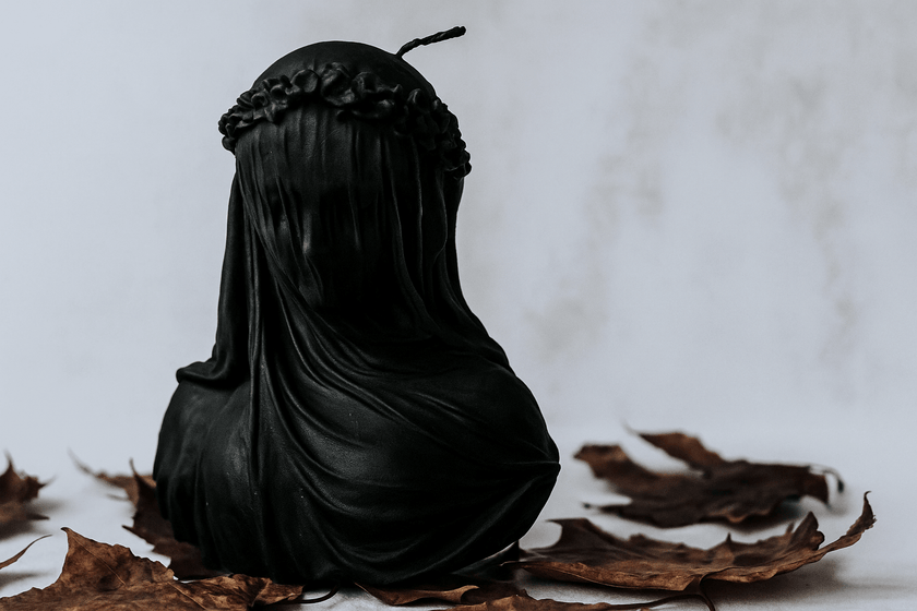 Handmade black soy wax Halloween candle with intricate veiled woman design for gothic home décor

