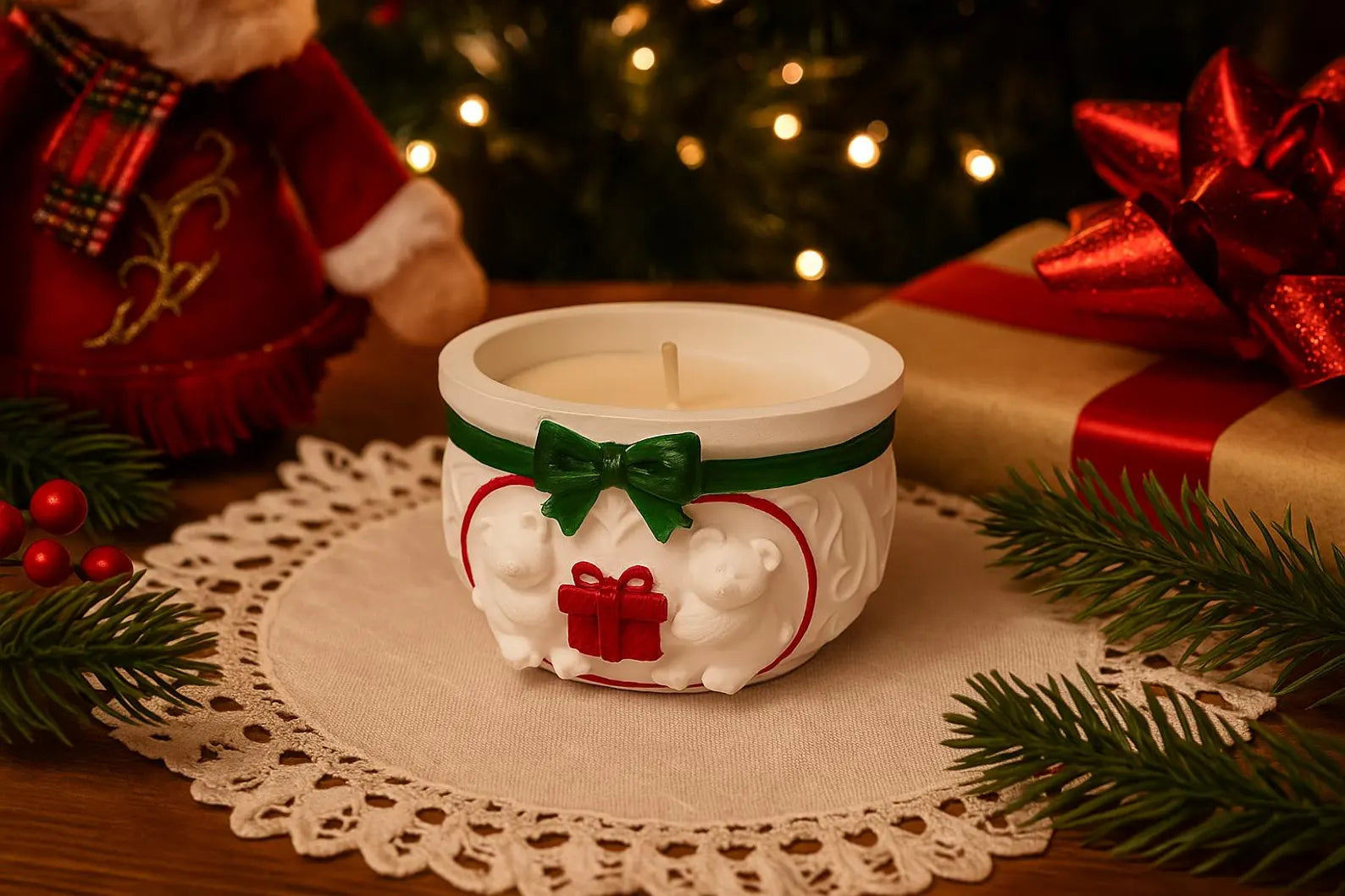 Decorative candle with a green bow on a doily, surrounded by Christmas decorations including a gift and tree.