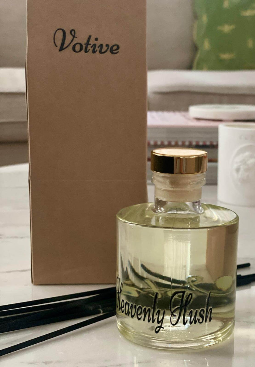 Heavenly Hush reed diffuser displayed on a wooden tray with leather accessories and modern decor

