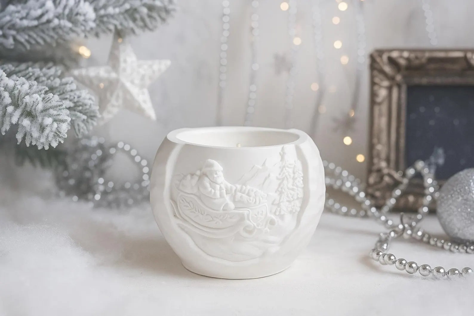 White ceramic mug with embossed design on a white surface with decorative elements.