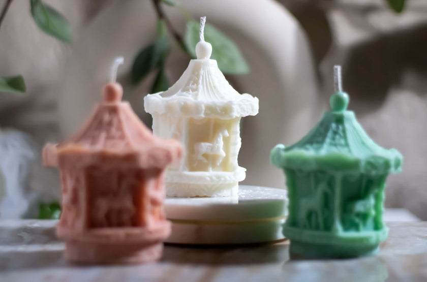 Christmas-themed candle carousel displayed on a wooden table, casting warm and enchanting shadows.