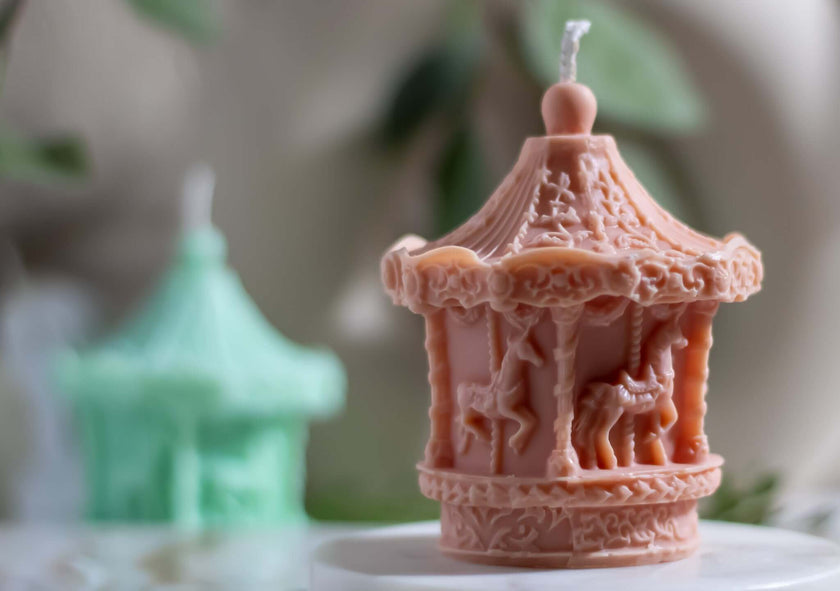 Festive Christmas candle carousel with spinning metallic ornaments, creating a magical holiday ambiance.