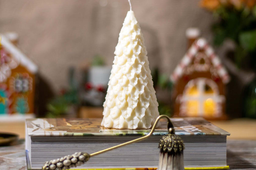 Christmas Fir Festivity candle displayed on a holiday-themed table, adding a cozy and elegant touch to seasonal décor.