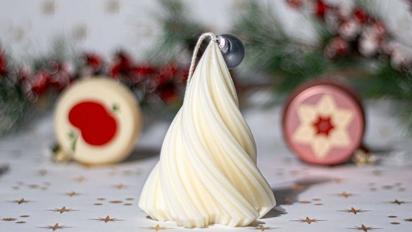 Small Christmas tree shaped scented candle in a festive setting, perfect for holiday ambiance.