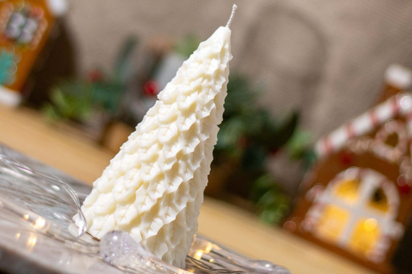 Eco-friendly scented candle in the shape of a fir tree, perfect for creating a warm and festive holiday atmosphere.