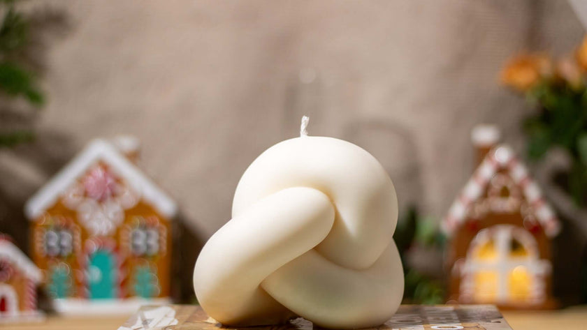 Handcrafted Mystic Radiance sculptural candle with an intricate knot design, made from eco-friendly natural wax.