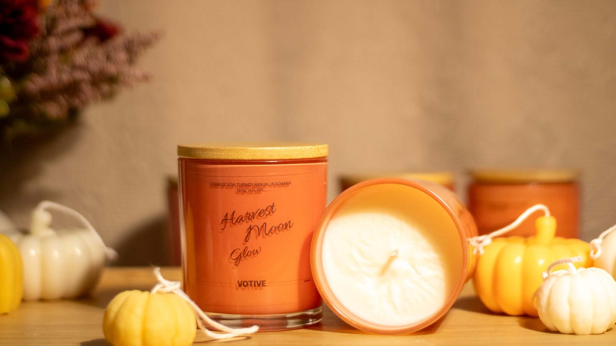 Eco-friendly soy wax candle infused with seasonal scents, perfect for creating a warm and inviting autumn ambiance.