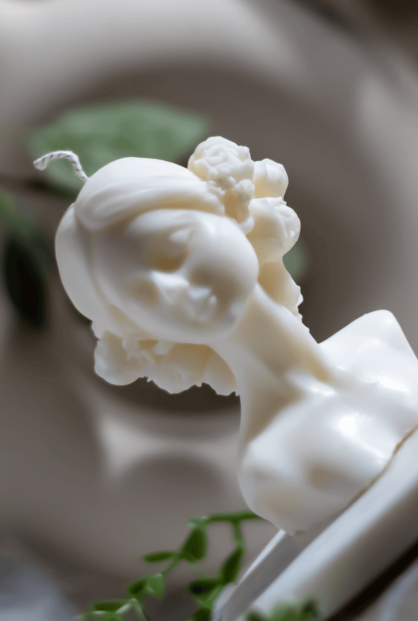 Hand-poured sculptural candle featuring a graceful woman bust, adorned with delicate floral details.