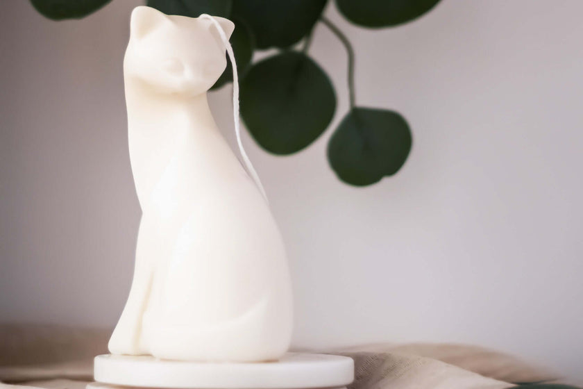 Close-up of the Cat Lady candle, showcasing intricate details of the woman and feline, symbolizing warmth and companionship.