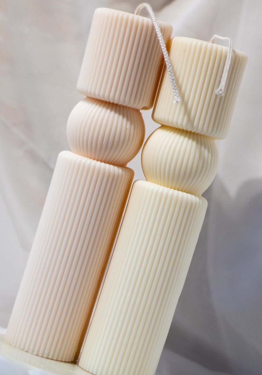 Hand-poured King’s Pillar decorative candle displayed on a wooden surface, blending sophistication with artisanal craftsmanship