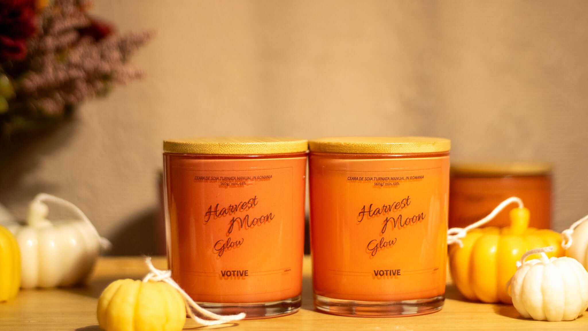 Close-up of the Harvest Moon Glow candle in a minimalist glass jar, releasing cozy fall aromas like spice and woodsy notes.