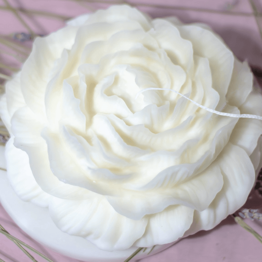 Luxury scented candle shaped like a blooming peony, infused with a refined floral fragrance for an elegant ambiance.