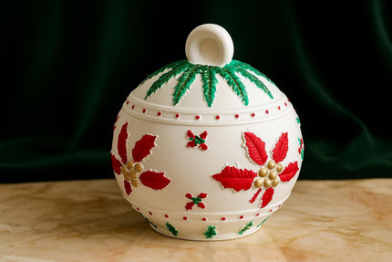 Decorative ceramic pot with floral patterns on a dark green background