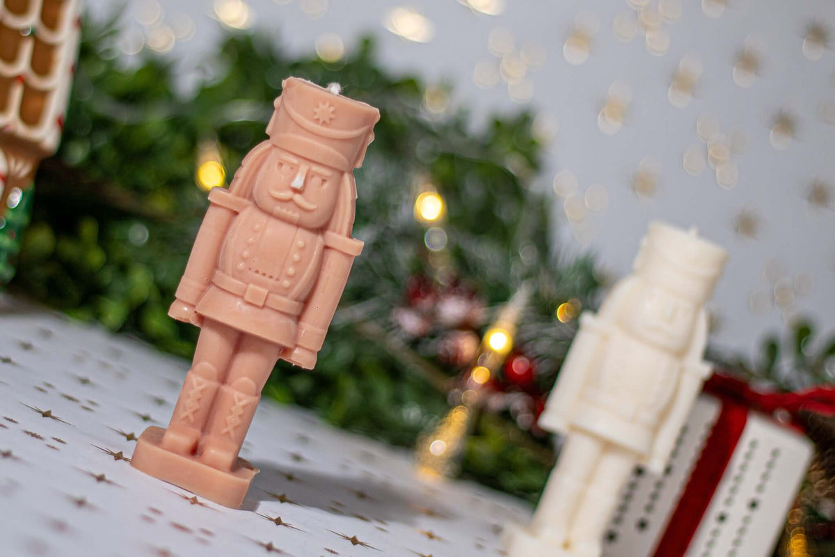 Nutcracker scented candles in festive decor, showcasing elegance and holiday spirit for Christmas decorations.