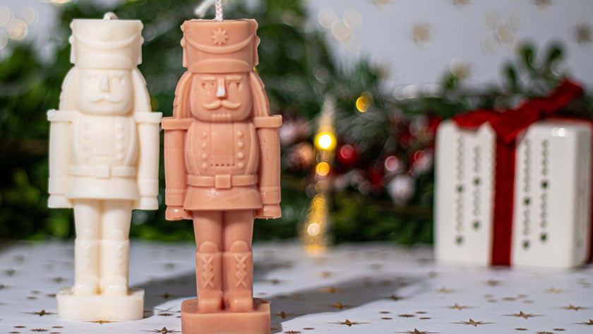 Nutcracker scented candles in white and pink hues, perfect for festive holiday decor.