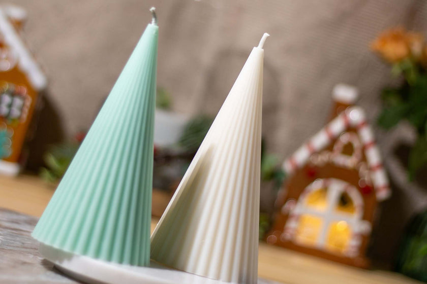 Two handcrafted decorative candles in mint green and white, perfect for Christmas decor and holiday gifting.