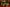 Set of Christmas tree-shaped candles on a table with a red tablecloth.