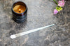 Stainless steel wick dipper – essential tool for candle enthusiasts.