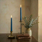 Taper candles displayed in candlesticks on a table setting