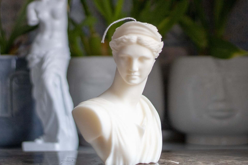 Artemis sculptural candle displayed on a dining table, creating a sophisticated and elegant ambiance.