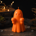 Handmade Halloween ghost candle holding orange pumpkins