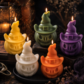 Five witch-hat shaped candle holders in yellow, green, purple, white, and orange, arranged on a dark surface with lit candles and warm ambient lighting. candles by Votive Candle Store