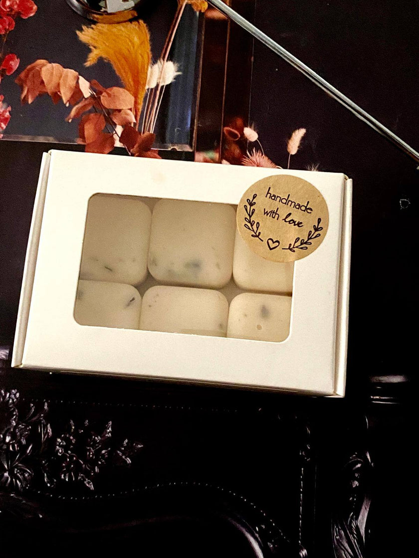 VOTIVE aromatherapy wax melts, non-toxic and vegan, displayed with a ceramic wax warmer