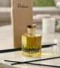 Collection of VOTIVE reed diffusers arranged in a sunlit living room with minimalist design


