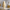 Wavy-patterned candle on a surface with decorative items in the background