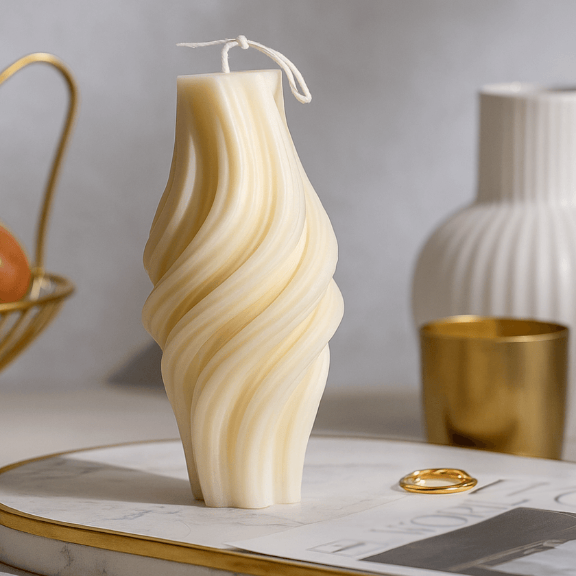 Wavy-patterned candle on a surface with decorative items in the background