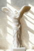 Elegant ivory candle sculpted as the Winged Victory of Samothrace, capturing classical Greek artistry in a refined wax replica.
